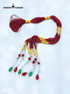 Traditional talwar dori with red and green beads, featuring intricate patterns and decorative tassels