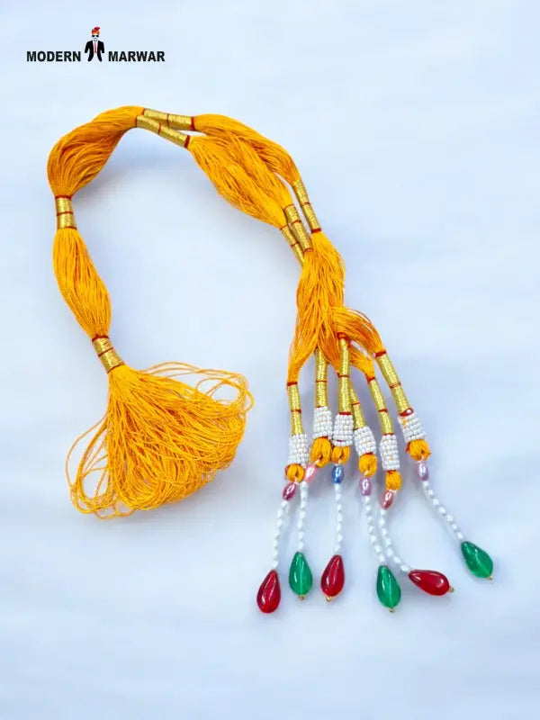 Vibrant yellow traditional talwar dori with decorative beads and tassels for traditional attire