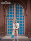Elegant wedding groom sherwani in mint green with traditional embellishments and a matching turban