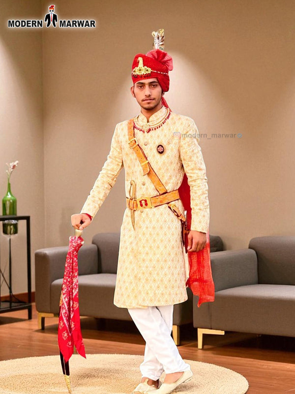 Elegant wedding groom sherwani in cream with intricate embroidery and red accessories