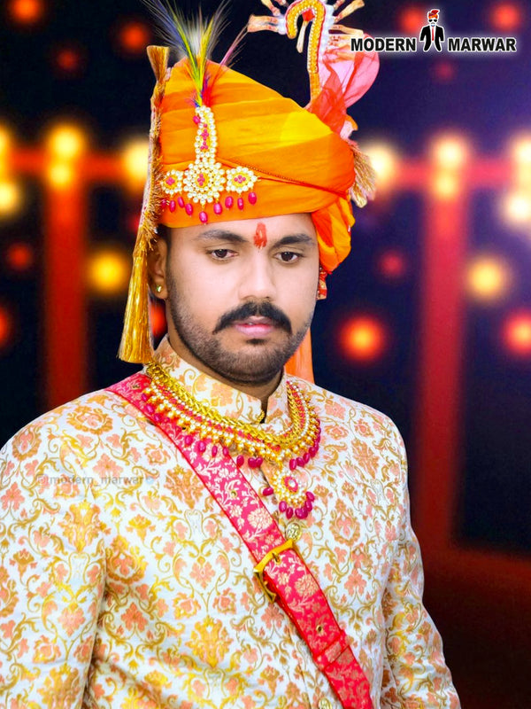 Elegant wedding groom sherwani with intricate gold embroidery and vibrant orange turban from Modern Marwar