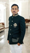 Modern Marwar designer men’s coat suit in dark green with intricate detailing and classic buttons