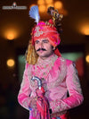 Elegant designer sherwani angarkha for men featuring intricate embroidery and traditional accessories