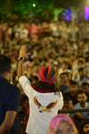Eagle logo shirt from Modern Marwar showcased at a lively event with a crowd in the background