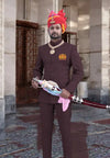 Man wearing a brown Jodhpuri suit with embroidered logo Jodhpuri and traditional turban for ceremonial occasions