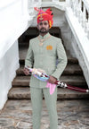 Elegant Jodhpuri suit in light green with embroidered logo Jodhpuri and a traditional sword accessory