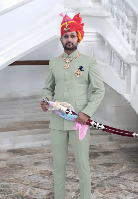 Elegant gents suit for wedding in light green, paired with traditional accessories and a royal turban