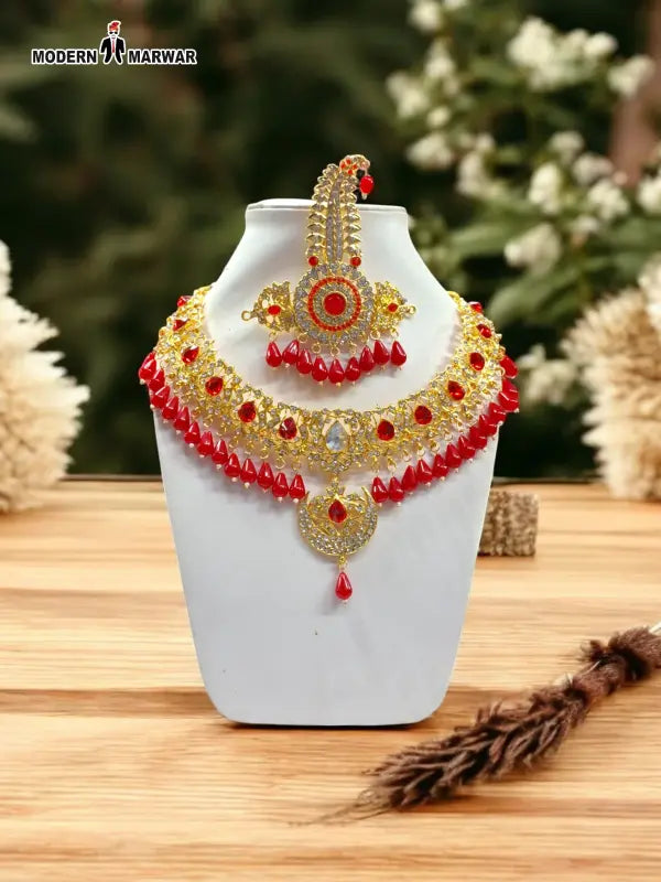 Gold and red necklace earring set with intricate design and sparkling details, perfect for special occasions