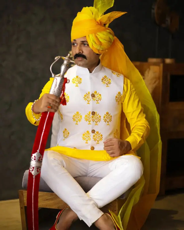 Traditional Haldi ceremony men's kurta set featuring vibrant yellow and white colors with intricate embroidery