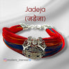 Jadeja logo moli bracelet with vibrant red and blue threads, featuring a decorative centerpiece