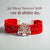 Jai Shree Sawriya Seth moli bracelet with red woven design and silver emblem for spiritual significance