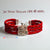 Jai Shree Shyam moli bracelet featuring red threads and a silver emblem, perfect for spiritual wear