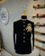 Elegant black Jodhpuri suit featuring an elephant logo Jodhpuri suit design with ornate details