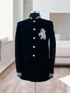 Elegant black Jodhpuri suit featuring an intricate elephant logo for stylish formal occasions