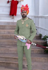 Elegant Jodhpuri suit for men in green with traditional accessories and regal styling