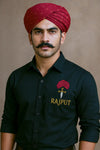Men's Rajput design shirt in black featuring embroidered logo and modeled with a traditional turban