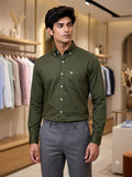 Men's green cotton plain shirt from SINGH displayed in a retail setting
