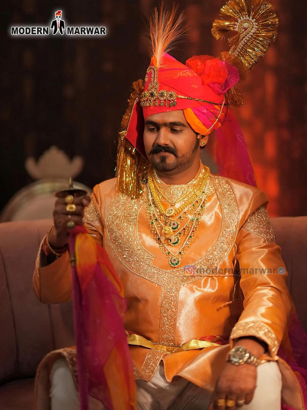 Elegant men's sherwani angarkha in peach with intricate embroidery and vibrant accessories