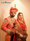 Stylish men's sherwani angarkha in vibrant orange with elegant embroidery, perfect for formal occasions