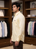 Men's shirt in yellow cotton fabric shown at a side angle, featuring SINGH branding, ideal for casual wear.