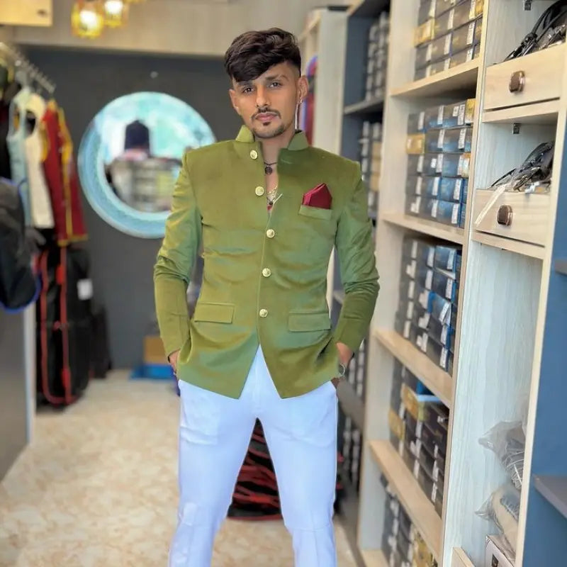 Stylish men's wedding coat suit in olive green with gold buttons and a coordinating pocket square