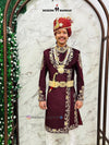 Designer maroon sherwani for men adorned with intricate golden embroidery and a decorative belt