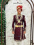 Designer maroon sherwani for men adorned with intricate golden embroidery and a decorative belt