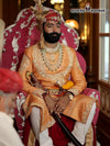 Elegant sherwani angarkha for men in orange with intricate embroidery and regal accessories