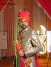 Elegant wedding groom sherwani with intricate embroidery and vibrant accessories for a royal look