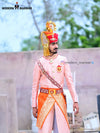 Elegant wedding groom sherwani in pink with intricate designs and embellished details