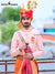 Traditional wedding groom sherwani in peach with intricate embroidery and matching accessories