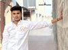 SINGH M Shirts Bishnoi logo shirt white worn by a man posing outdoors with hand on wall