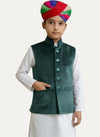 Modern Marwar kids' emerald green velvet Nehru jacket with button front and pockets, paired with white kurta and multi-colored turban.