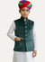 Modern Marwar kids' emerald green velvet Nehru jacket with button front and pockets, paired with white kurta and multi-colored turban.