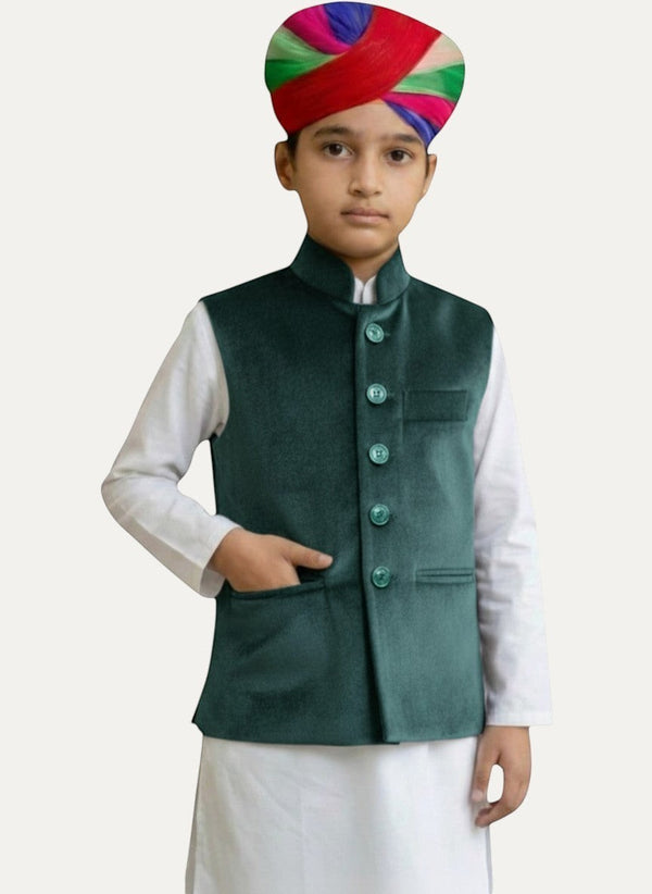 Modern Marwar kids' emerald green velvet Nehru jacket with button front and pockets, paired with white kurta and multi-colored turban.