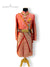 Premium groom sherwani in coral with intricate patterns and traditional embellishments for weddings