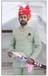 Elegant Rajputi Jodhpuri Suit in mint green for men, styled with royal accessories and a traditional turban.