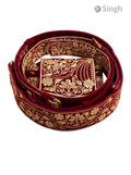 Red embroidered velvet Sherwani Belt-2800-5 in a coiled position showcasing intricate designs