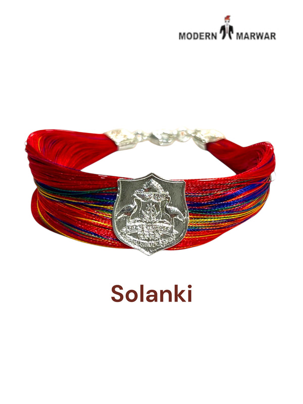 Default red woven fabric bracelet at an angle featuring the Solanki logo moli bracelet