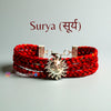 Surya logo moli bracelet with a sun design and red braided straps for a stylish accessory.