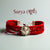 Surya logo moli bracelet with a sun design and red braided straps for a stylish accessory.