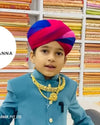 Young boy wearing a Jaisalmeri Safa for weddings, showcasing vibrant colors and traditional style.