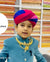 Young boy wearing a Jaisalmeri Safa for weddings, showcasing vibrant colors and traditional style.
