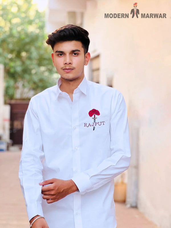 White men's Rajput design shirt with red embroidered emblem worn by a young man
