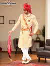 Elegant wedding groom sherwani in cream with intricate designs and matching accessories