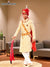 Elegant wedding groom sherwani in cream with intricate embroidery and red accessories